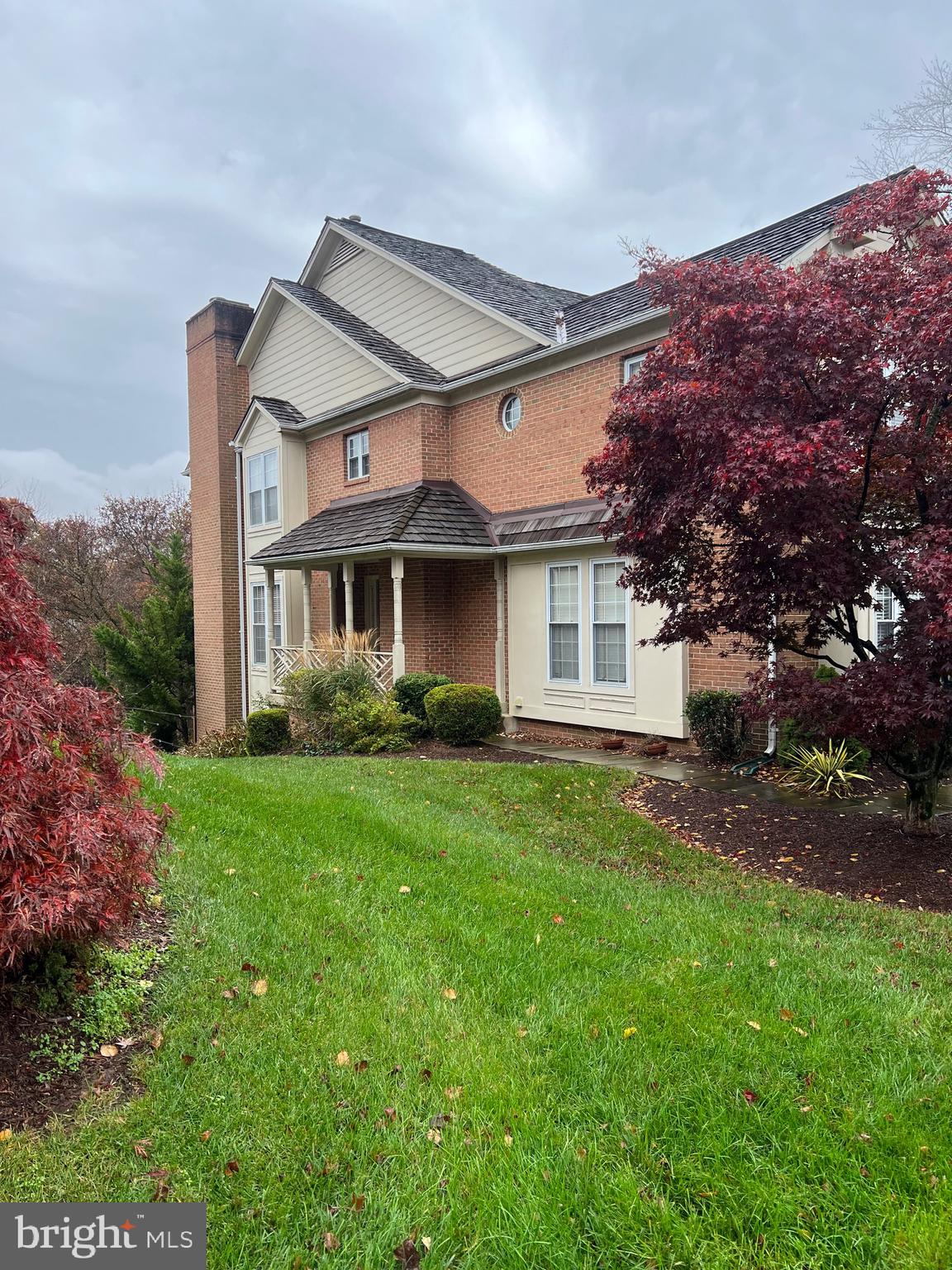 a view of a yard in front of a house with large tree