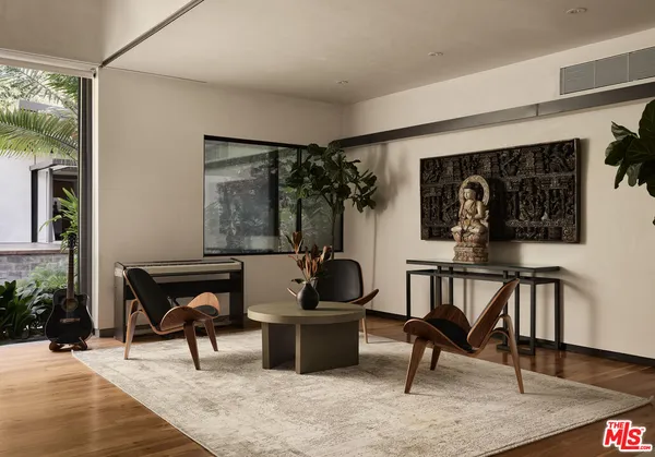 a living room with furniture and a potted plant