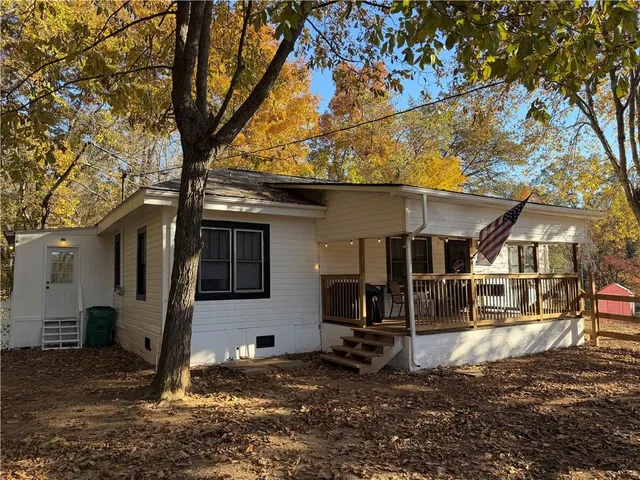 a backyard of a house with barbeque oven