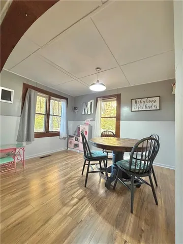 a view of a dining room with furniture and wooden floor