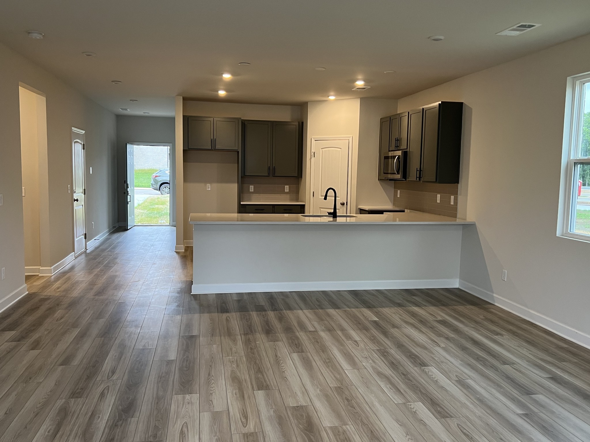 4111 Dwight Way Murfreesboro, TN 37128 - Photo 17 of 28 a view of a kitchen with kitchen island a sink wooden floor and stainless steel appliances