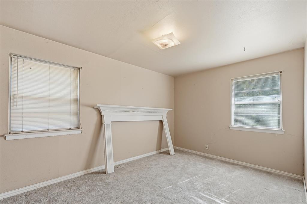 206 West Ridgewood Drive Garland, TX 75041 - Photo 11 of 21 an empty room with windows and closet