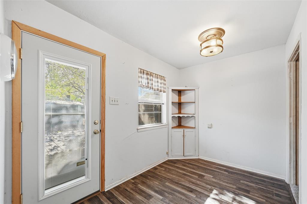 206 West Ridgewood Drive Garland, TX 75041 - Photo 17 of 21 a view of a hallway with wooden floor and a window