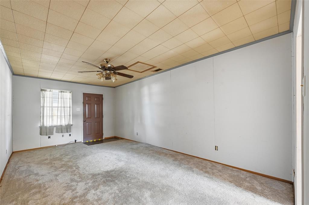 206 West Ridgewood Drive Garland, TX 75041 - Photo 19 of 21 an empty room with windows and fan
