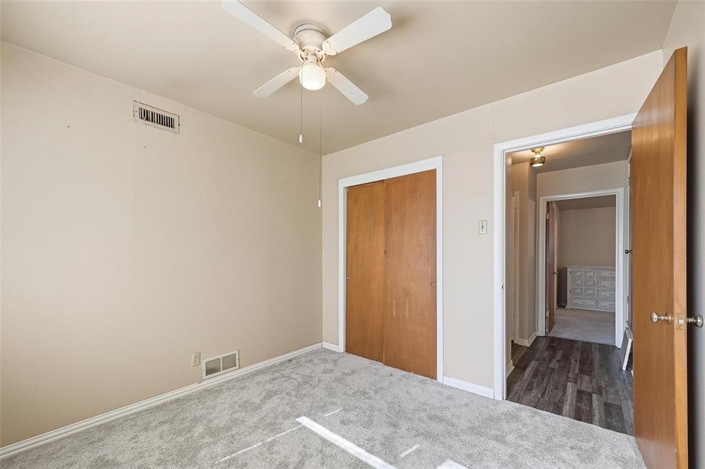 206 West Ridgewood Drive Garland, TX 75041 - Photo 20 of 21 a view of a big room with wooden floor and closet area