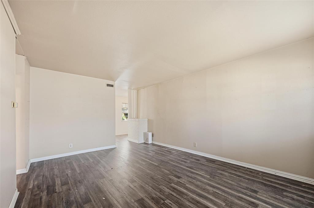 206 West Ridgewood Drive Garland, TX 75041 - Photo 7 of 21 a view of an empty room with wooden floor