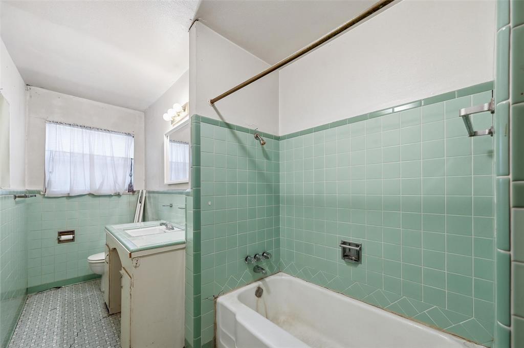 206 West Ridgewood Drive Garland, TX 75041 - Photo 8 of 21 a bathroom with a sink a toilet and shower