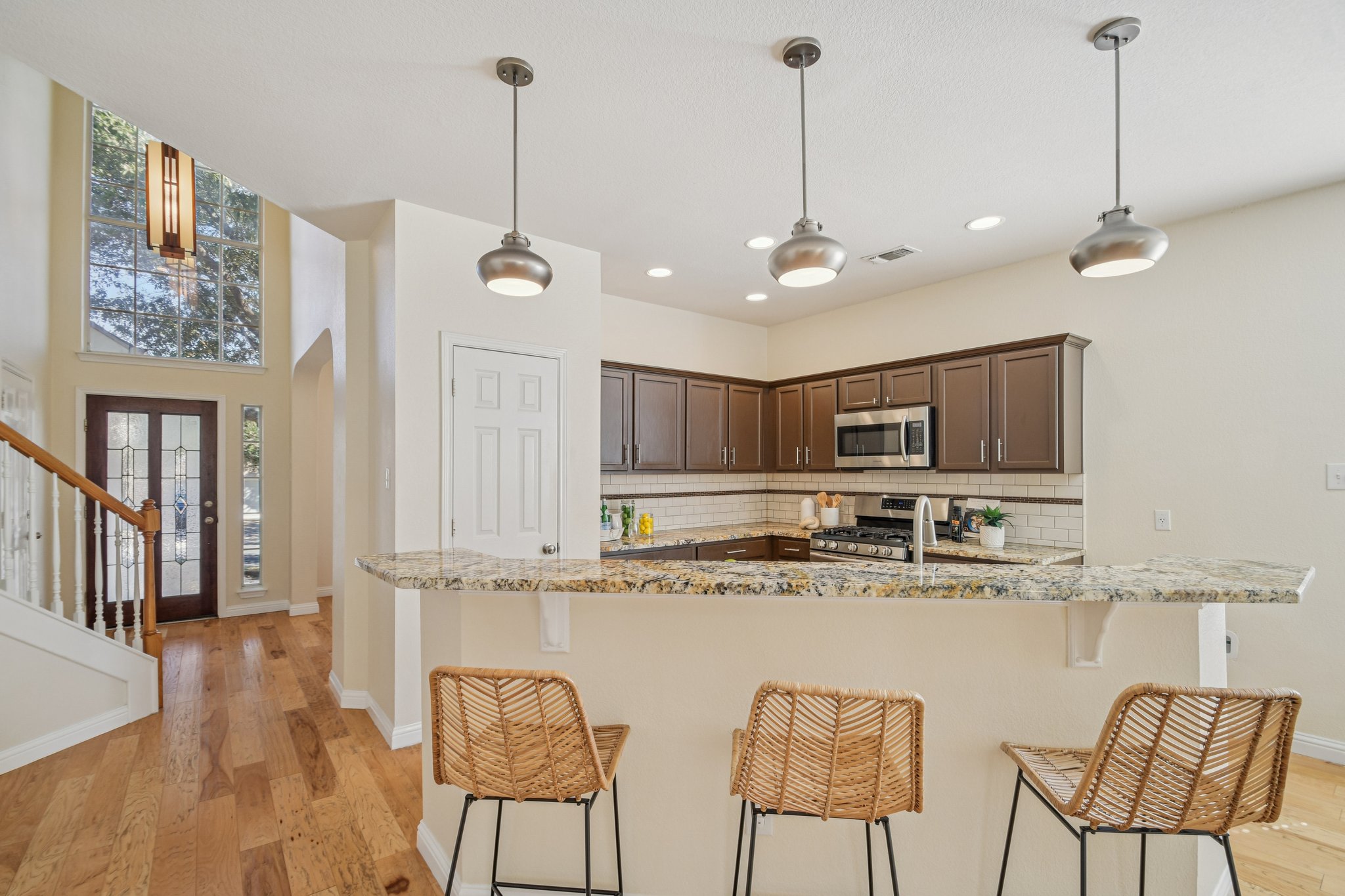 5947 Lomita Verde Circle Austin, TX 78749 - Photo 13 of 40 a kitchen with stainless steel appliances granite countertop a stove a sink and a refrigerator with wooden floor
