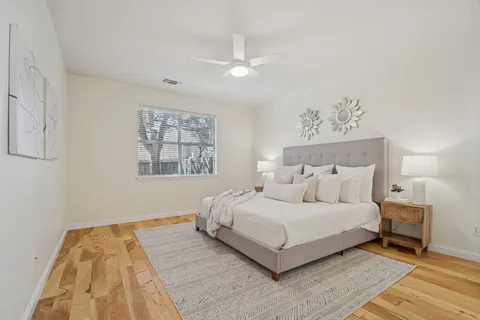 a bedroom with a large bed and a chandelier
