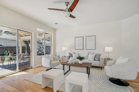 a living room with furniture and a wooden floor