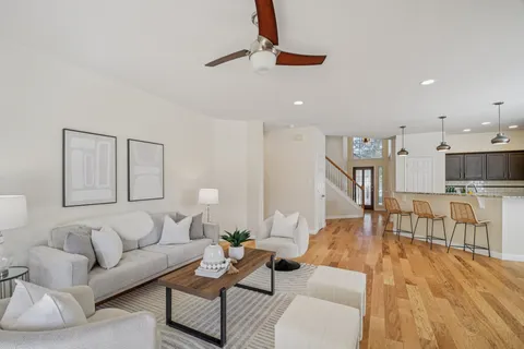 a living room with furniture a fireplace and a table
