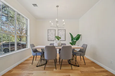 a view of a dining room with furniture window and wooden floor