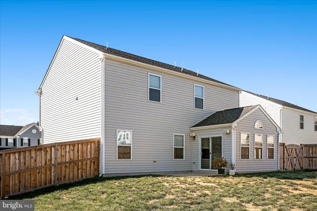 a view of a balcony with two chairs and a rug