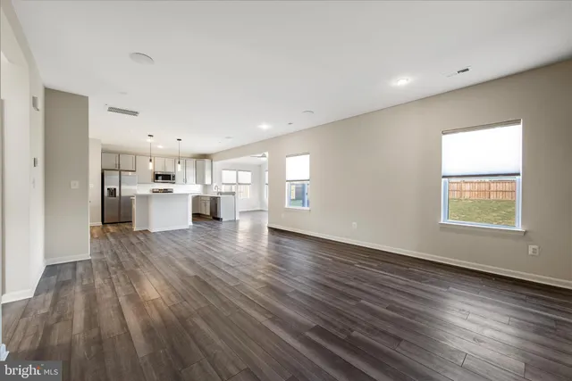 a view of a kitchen with a sink and a refrigerator