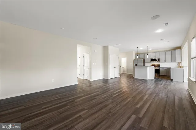 a view of a room with wooden floor and a window