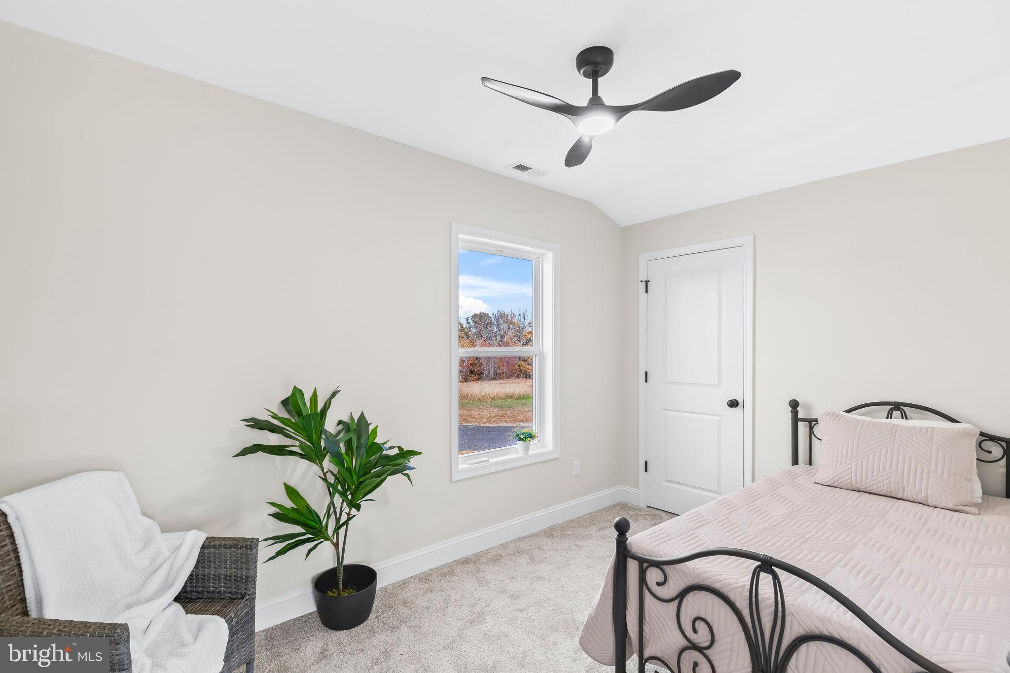 1710 Old Adelina Road Prince Frederick, MD 20678 - Photo 12 of 38 Serene bedroom with natural light and greenery.