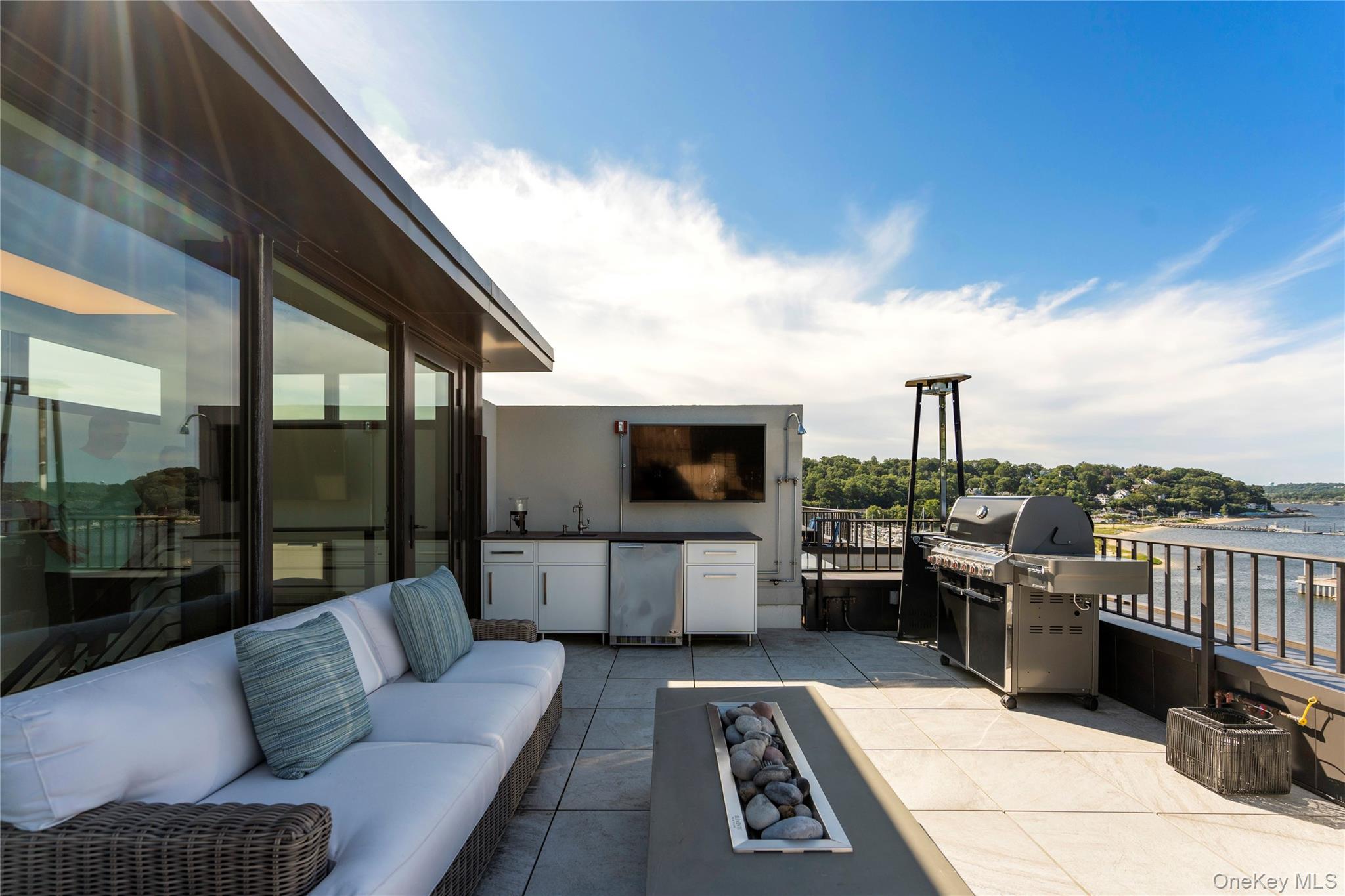 100 Garvies Point Road, Unit 1309 Glen Cove, NY 11542 - Photo 22 of 36 View of rooftop terrace with an outdoor kitchen and a water view