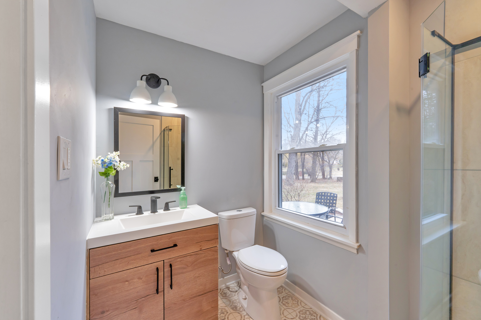 349 Haman Road Inverness, IL 60067 - Photo 20 of 36 a bathroom with a toilet a sink and mirror