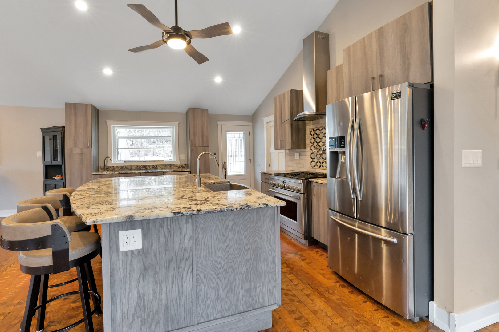 349 Haman Road Inverness, IL 60067 - Photo 8 of 36 a kitchen with stainless steel appliances granite countertop a refrigerator a stove a sink a dining table and chairs with wooden floor