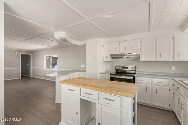 a kitchen with a sink a stove and cabinets