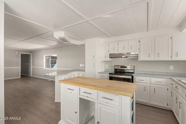 a kitchen with a sink a stove and cabinets