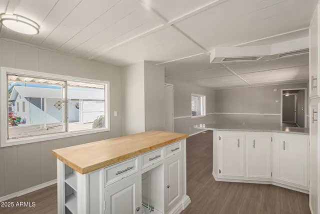 a kitchen with a sink window and cabinets
