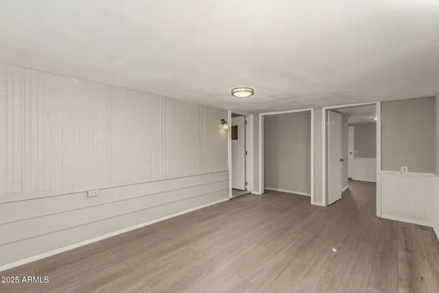 a view of an empty room and wooden floor