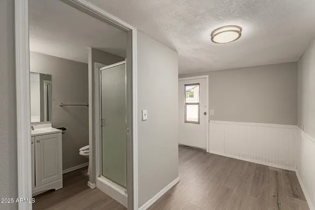 a view of an empty room with closet and a window