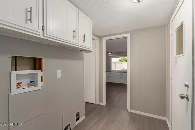 a view of an empty room with closet and a window