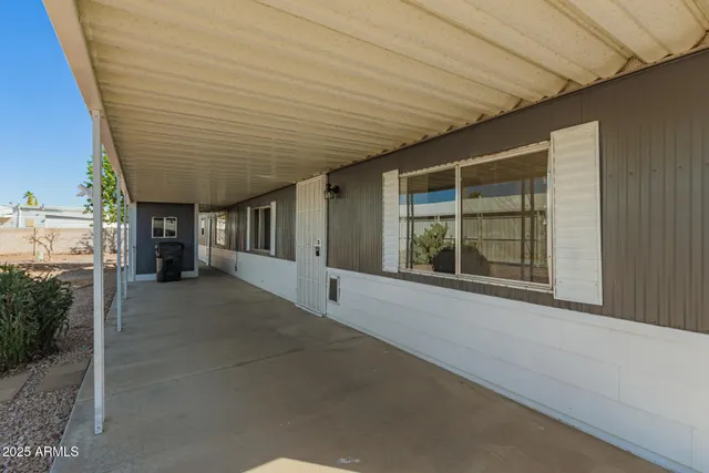 a view of a house with a roof and wooden fence
