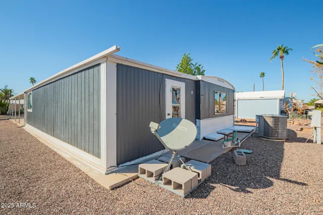 a view of a chairs and table in backyard of the house