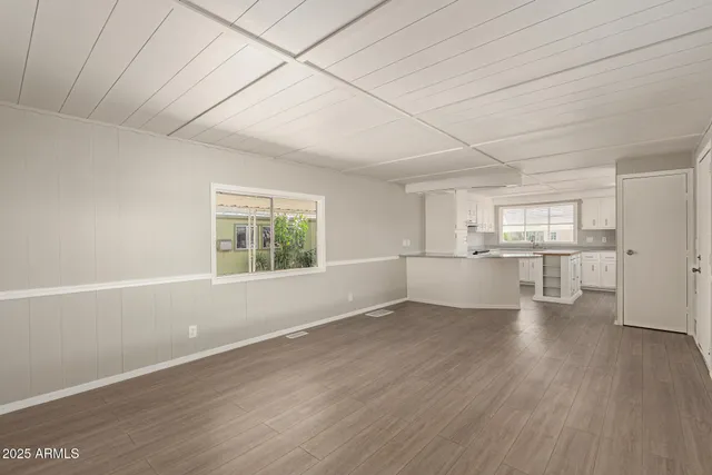 a view of a kitchen with wooden floor and electronic appliances