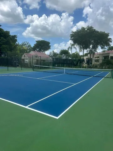 a view of an outdoor space and tennis court