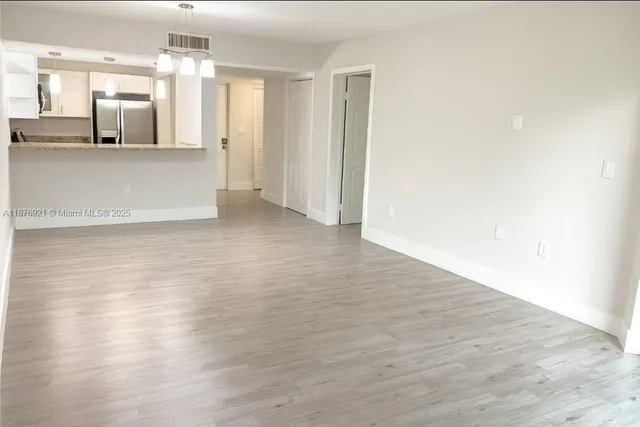 a view of a kitchen with wooden floor