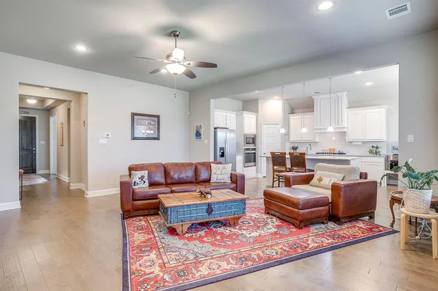 a living room with furniture a large window and a fireplace