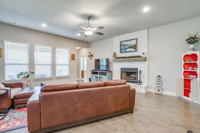 a living room with furniture fireplace and window