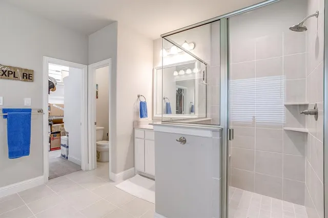 a bathroom with a shower and a mirror