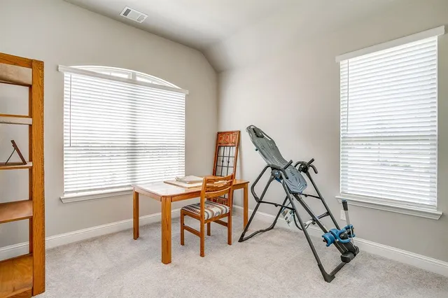 a room with gym equipment and a window