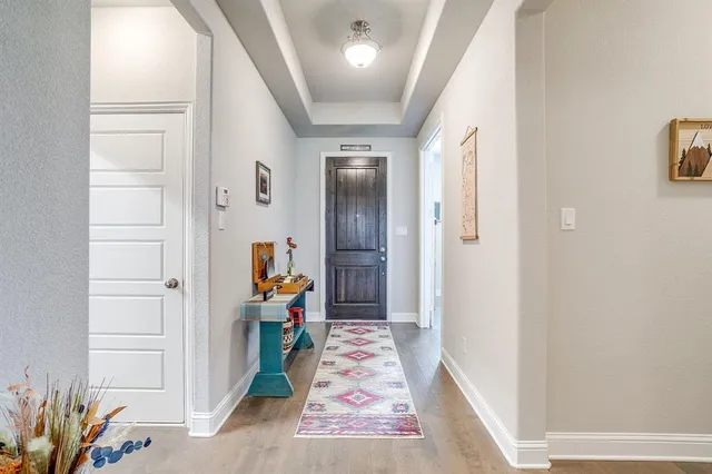 a view of a hallway with paintings on the wall