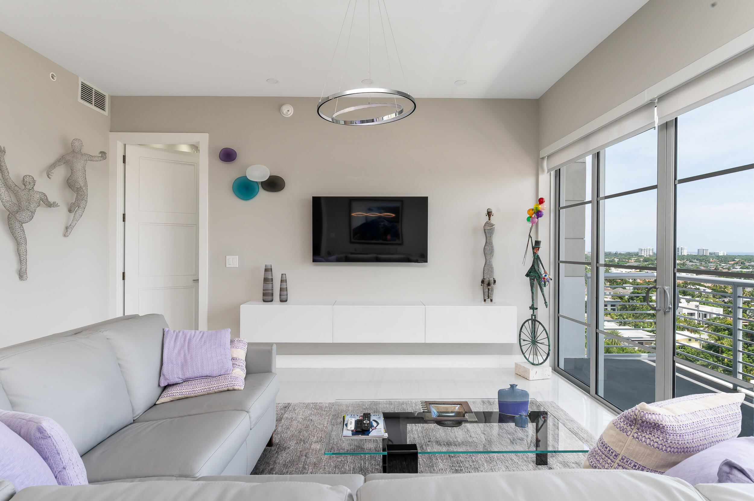 155 East Boca Raton Road, Unit 1107 Boca Raton, FL 33432 - Photo 5 of 53 a living room with furniture and a flat screen tv