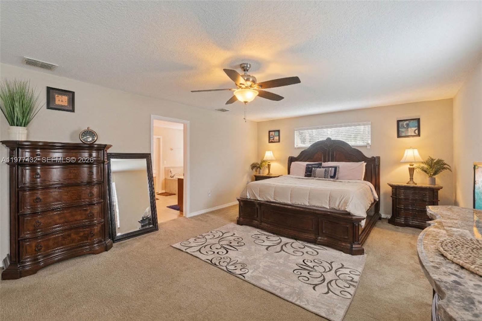 2502 Woodside Ridge Drive Apopka, FL 32712 - Photo 13 of 37 a bedroom with a bed and dresser