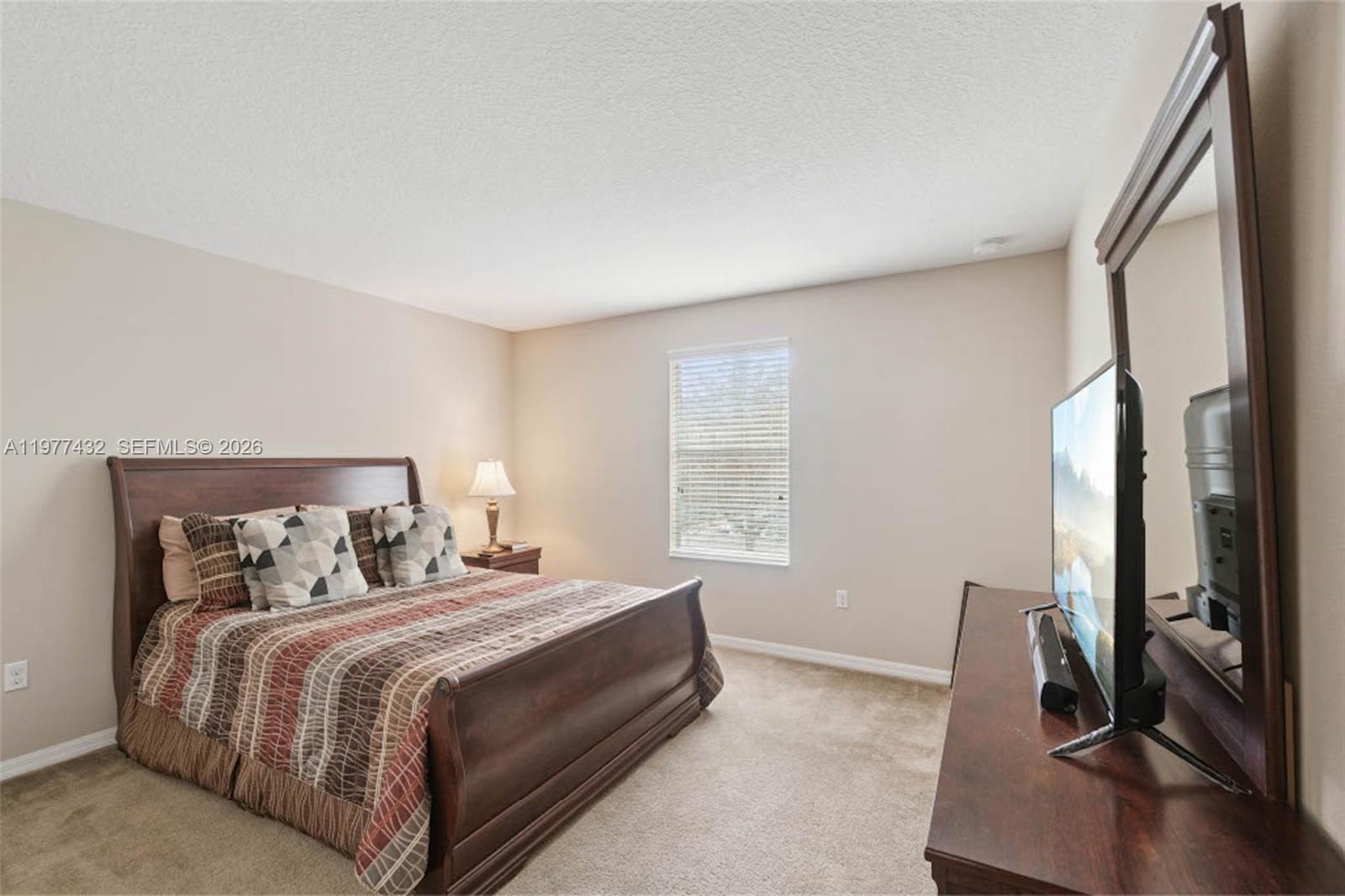 2502 Woodside Ridge Drive Apopka, FL 32712 - Photo 20 of 37 a bedroom with a bed and a large window