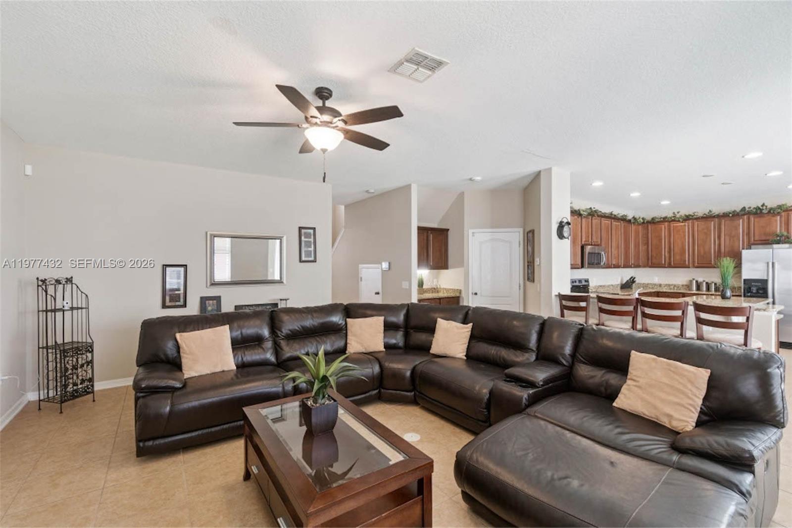 2502 Woodside Ridge Drive Apopka, FL 32712 - Photo 3 of 37 a living room with furniture ceiling fan and a rug