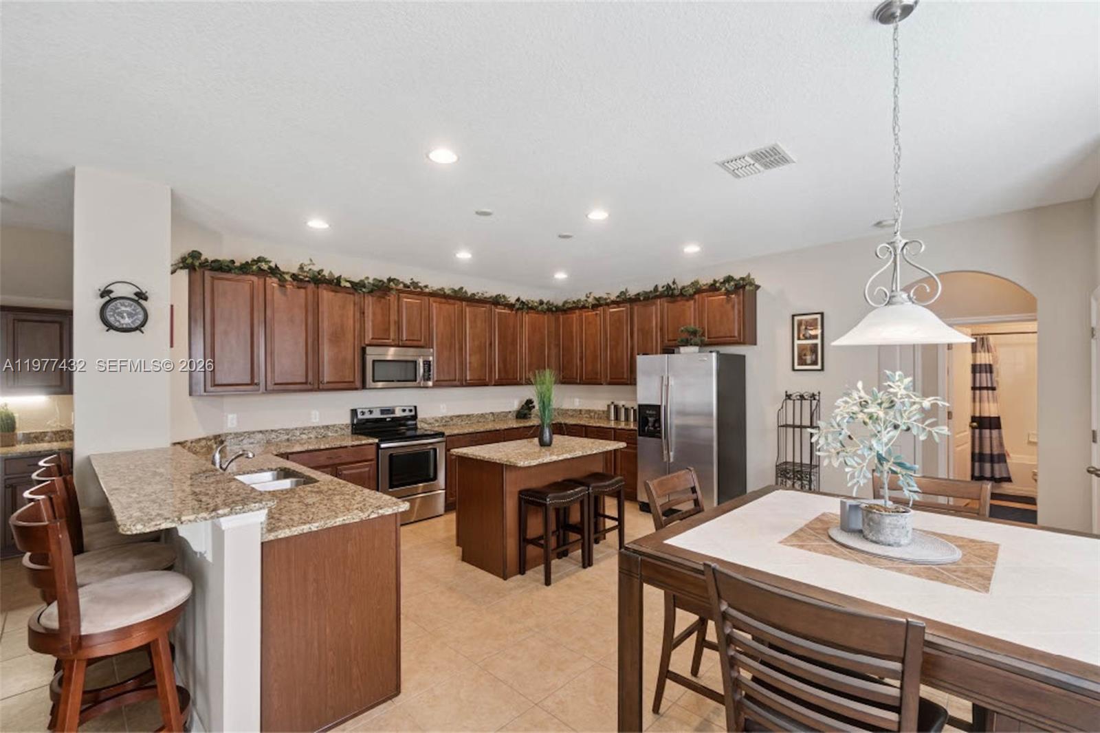 2502 Woodside Ridge Drive Apopka, FL 32712 - Photo 7 of 37 a kitchen with a table chairs stove and refrigerator