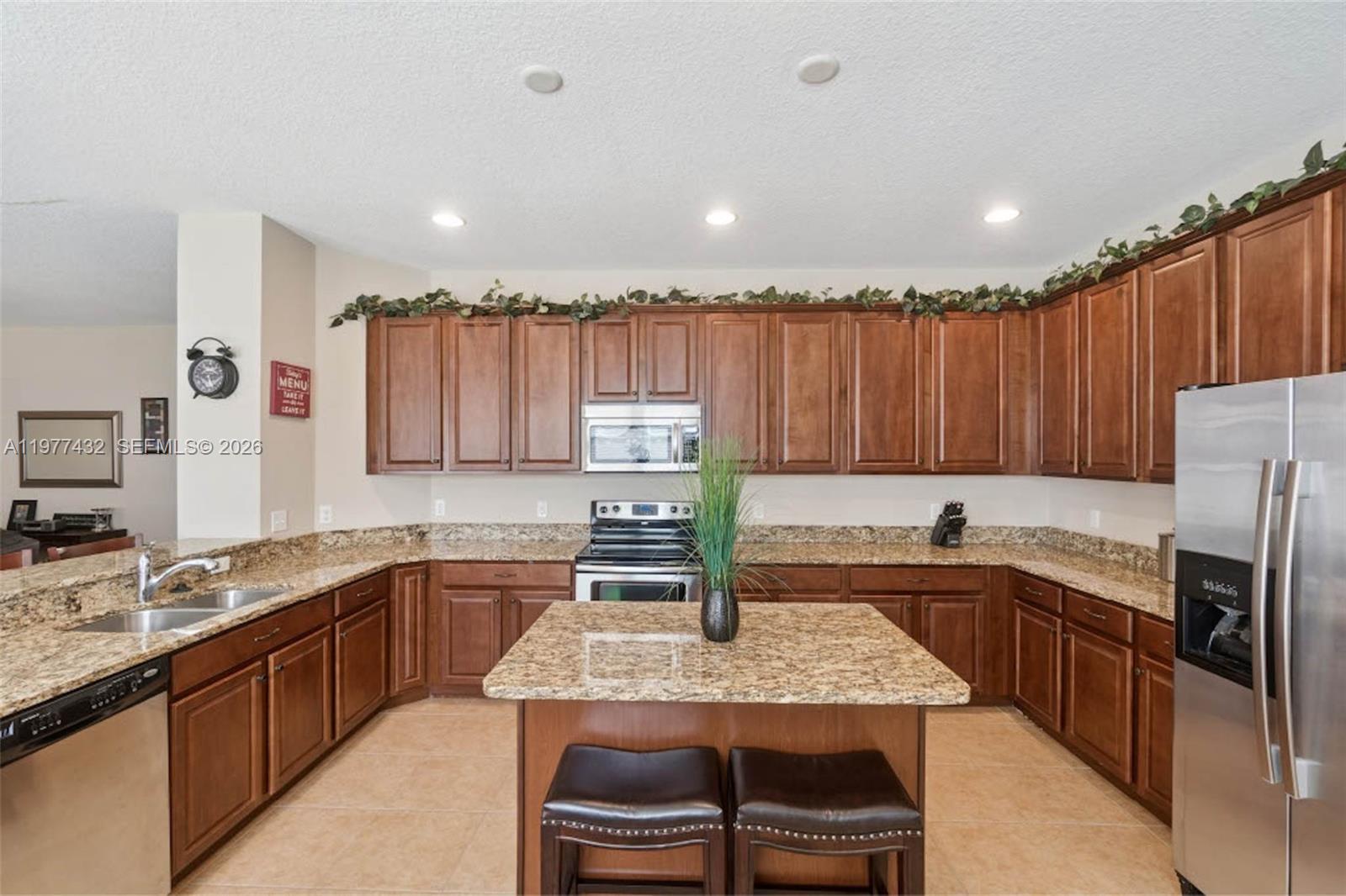 2502 Woodside Ridge Drive Apopka, FL 32712 - Photo 8 of 37 a kitchen with a sink a counter top space cabinets and stainless steel appliances