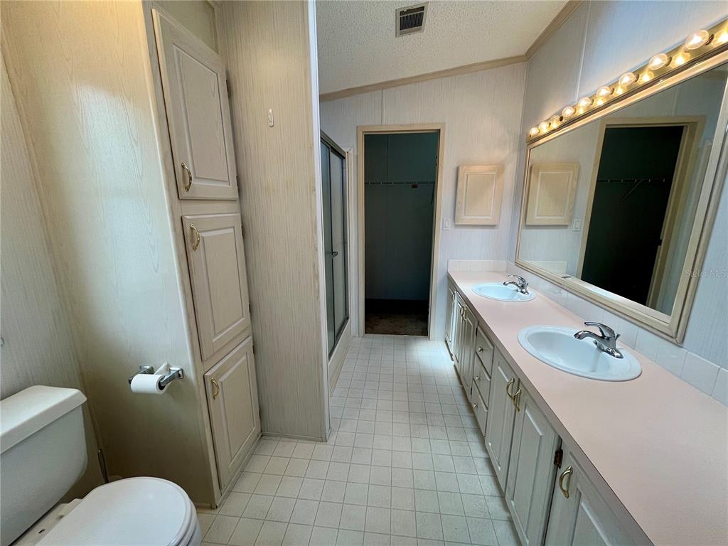 10614 Hayden Avenue New Port Richey, FL 34655 - Photo 11 of 23 a bathroom with a sink a mirror and a toilet