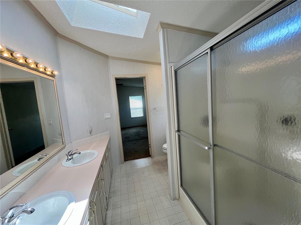10614 Hayden Avenue New Port Richey, FL 34655 - Photo 12 of 23 a bathroom with a tub and shower