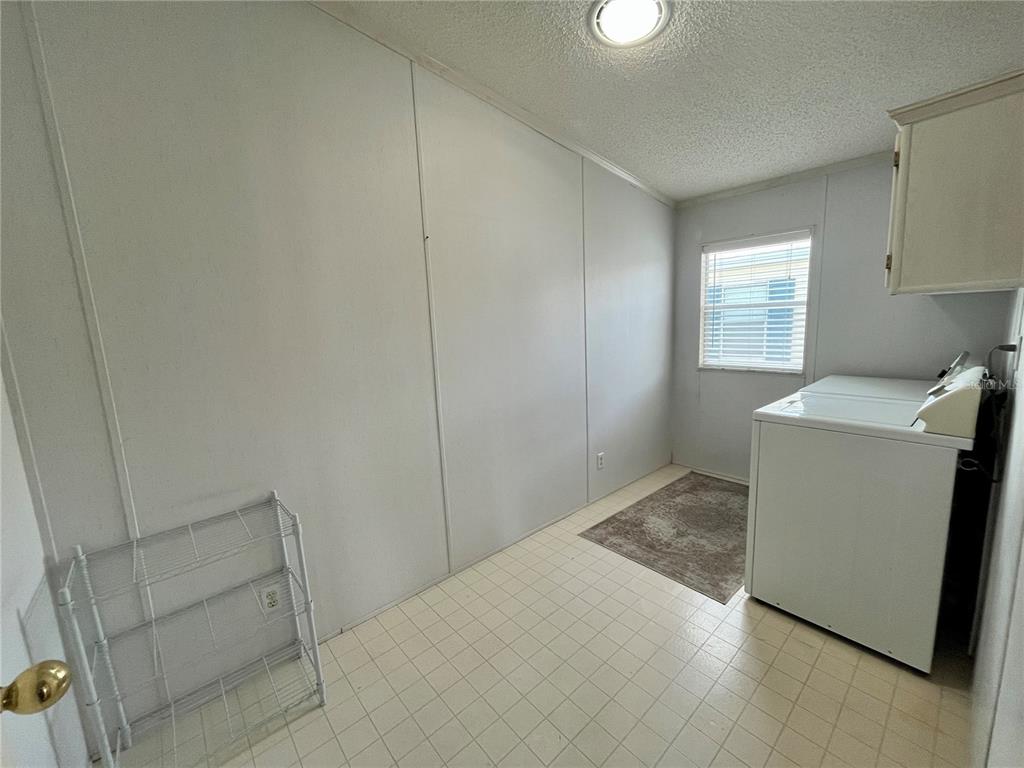 10614 Hayden Avenue New Port Richey, FL 34655 - Photo 15 of 23 a view of storage and utility room with washer and dryer