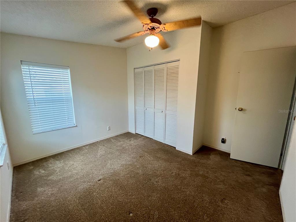 10614 Hayden Avenue New Port Richey, FL 34655 - Photo 18 of 23 an empty room with windows and fan