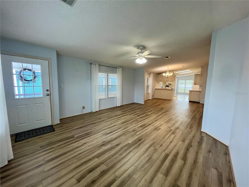 10614 Hayden Avenue New Port Richey, FL 34655 - Photo 3 of 23 wooden floor in an empty room with a window